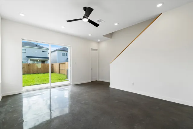 a view of a room with an empty space and a ceiling fan