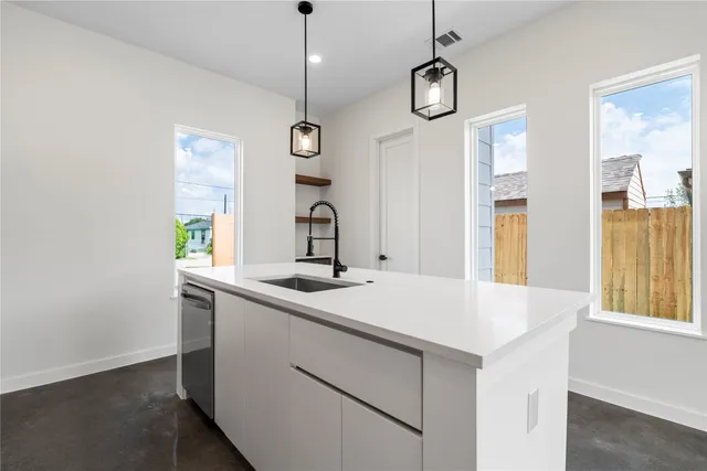a view of a kitchen with a sink and window