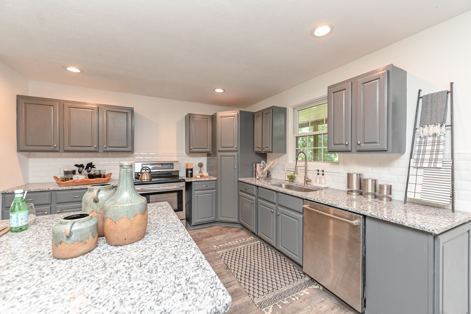 665 Hog Back Ridge Road Bethpage, TN 37022 - Photo 5 of 66 a kitchen with stainless steel appliances granite countertop a sink stove and cabinets