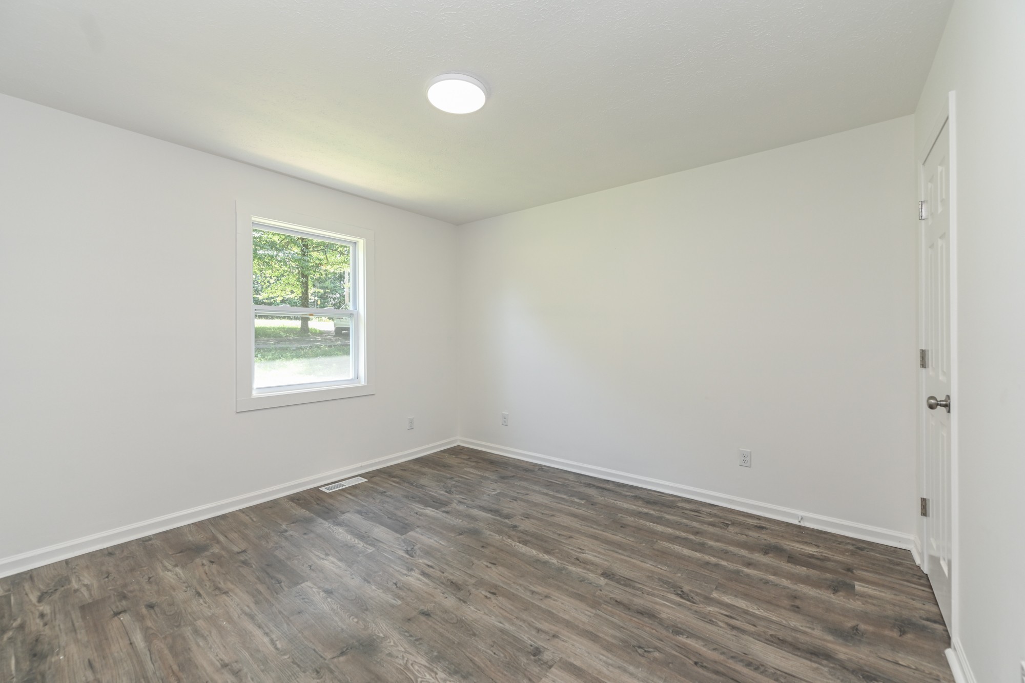 665 Hog Back Ridge Road Bethpage, TN 37022 - Photo 54 of 66 an empty room with wooden floor and windows