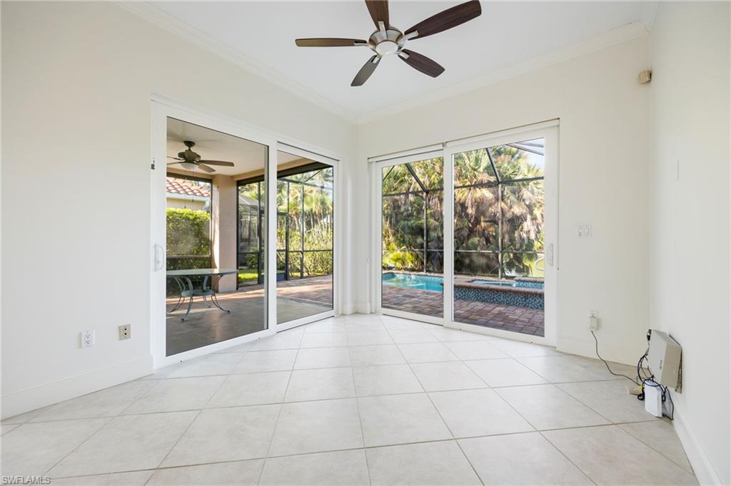 982 Fountain Run Naples, FL 34119 - Photo 17 of 44 Unfurnished room with a sunroom, ceiling fan, crown molding, healthy amount of natural light, and light tile patterned floors