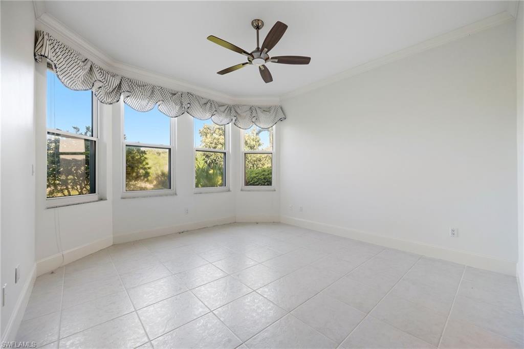 982 Fountain Run Naples, FL 34119 - Photo 19 of 44 Spare room featuring crown molding, ceiling fan, and light tile patterned flooring
