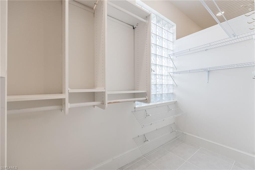 982 Fountain Run Naples, FL 34119 - Photo 21 of 44 Walk in closet featuring light tile patterned floors