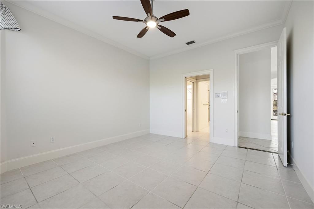 982 Fountain Run Naples, FL 34119 - Photo 22 of 44 Unfurnished bedroom with ornamental molding, ceiling fan, and light tile patterned flooring