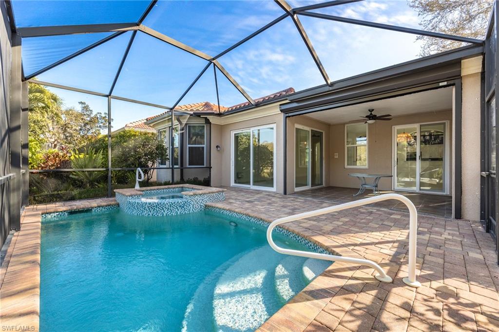 982 Fountain Run Naples, FL 34119 - Photo 32 of 44 Combined pool / hot tub featuring a sunroom, glass enclosure, and a patio