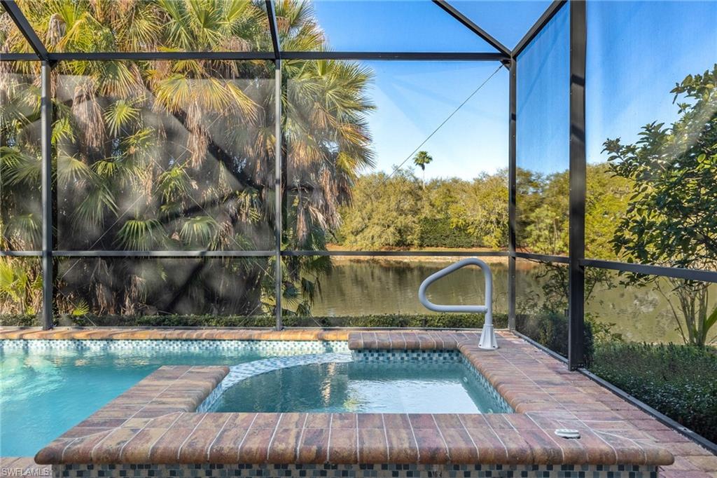 982 Fountain Run Naples, FL 34119 - Photo 34 of 44 Integrated pool / spa with a lanai, a sunroom, and a water view