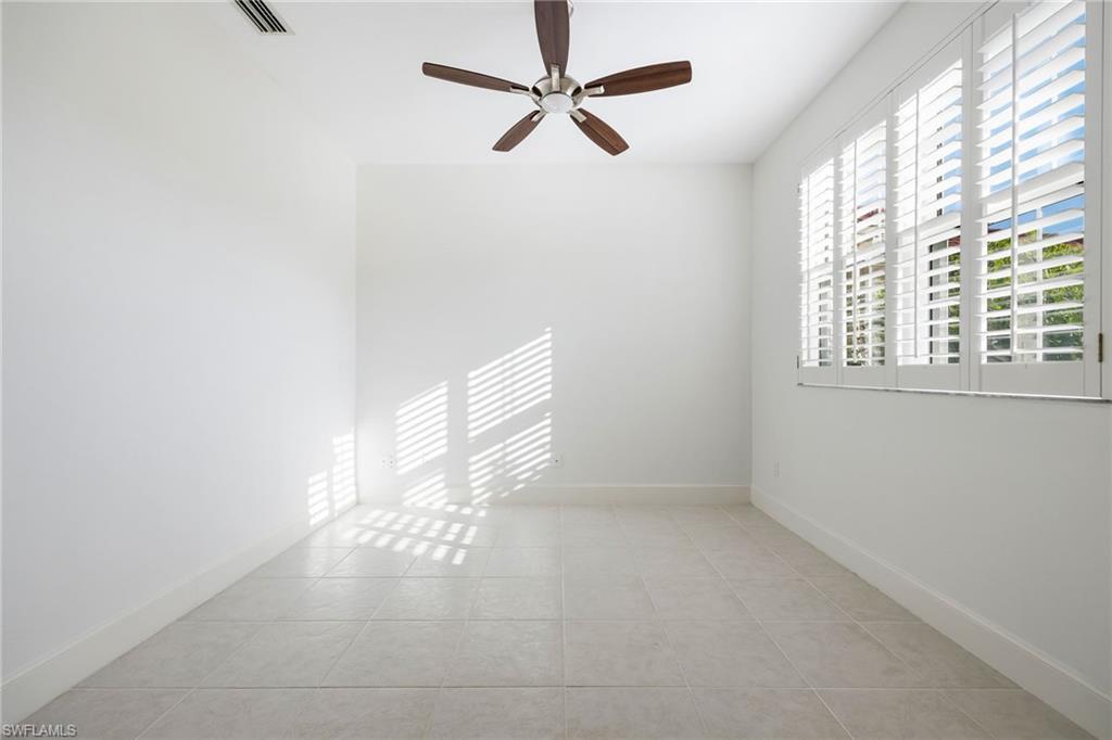982 Fountain Run Naples, FL 34119 - Photo 4 of 44 Empty room with ceiling fan and light tile patterned flooring