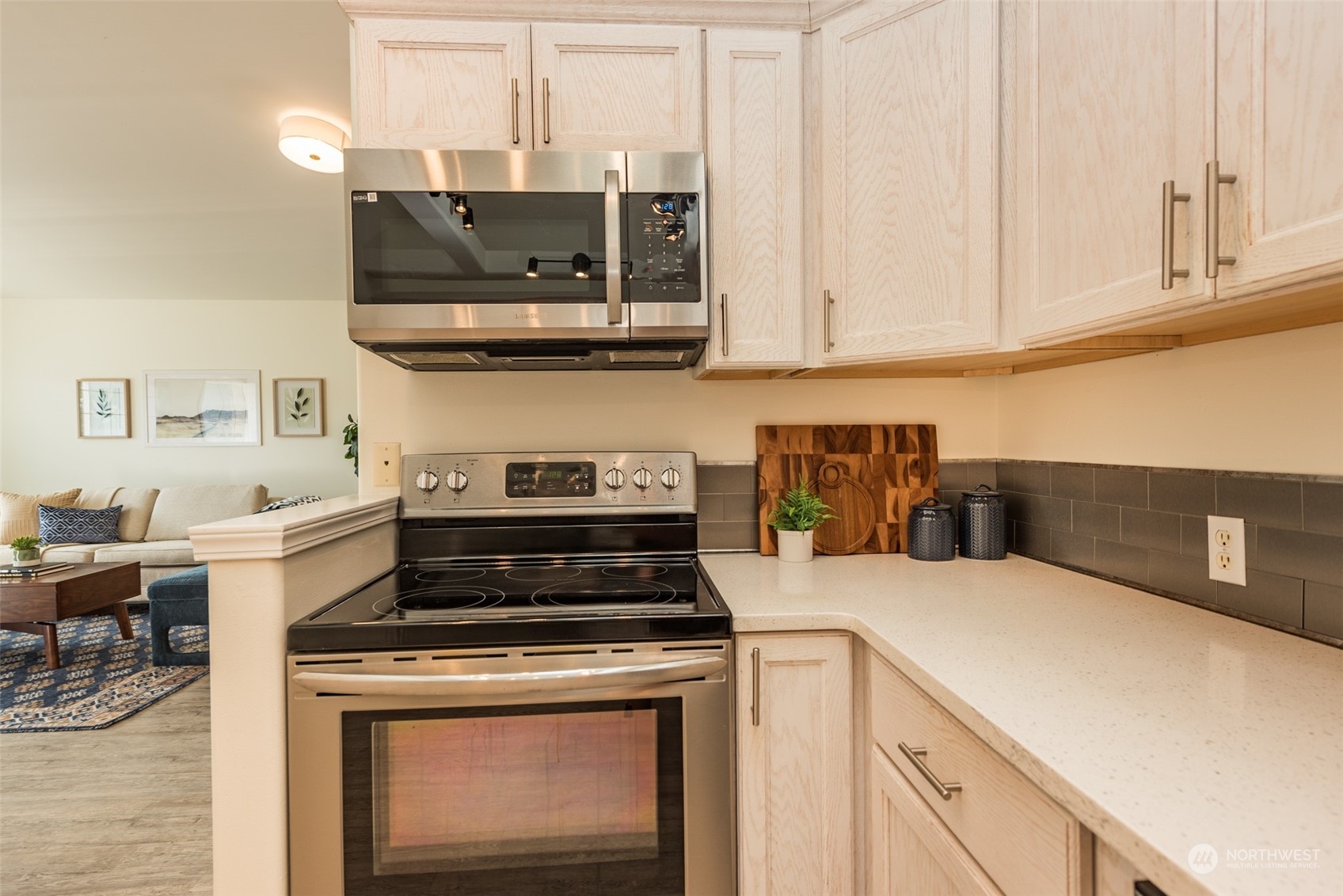 818 East Washington Place Sequim, WA 98382 - Photo 11 of 28 a kitchen with stainless steel appliances a stove a microwave and cabinets