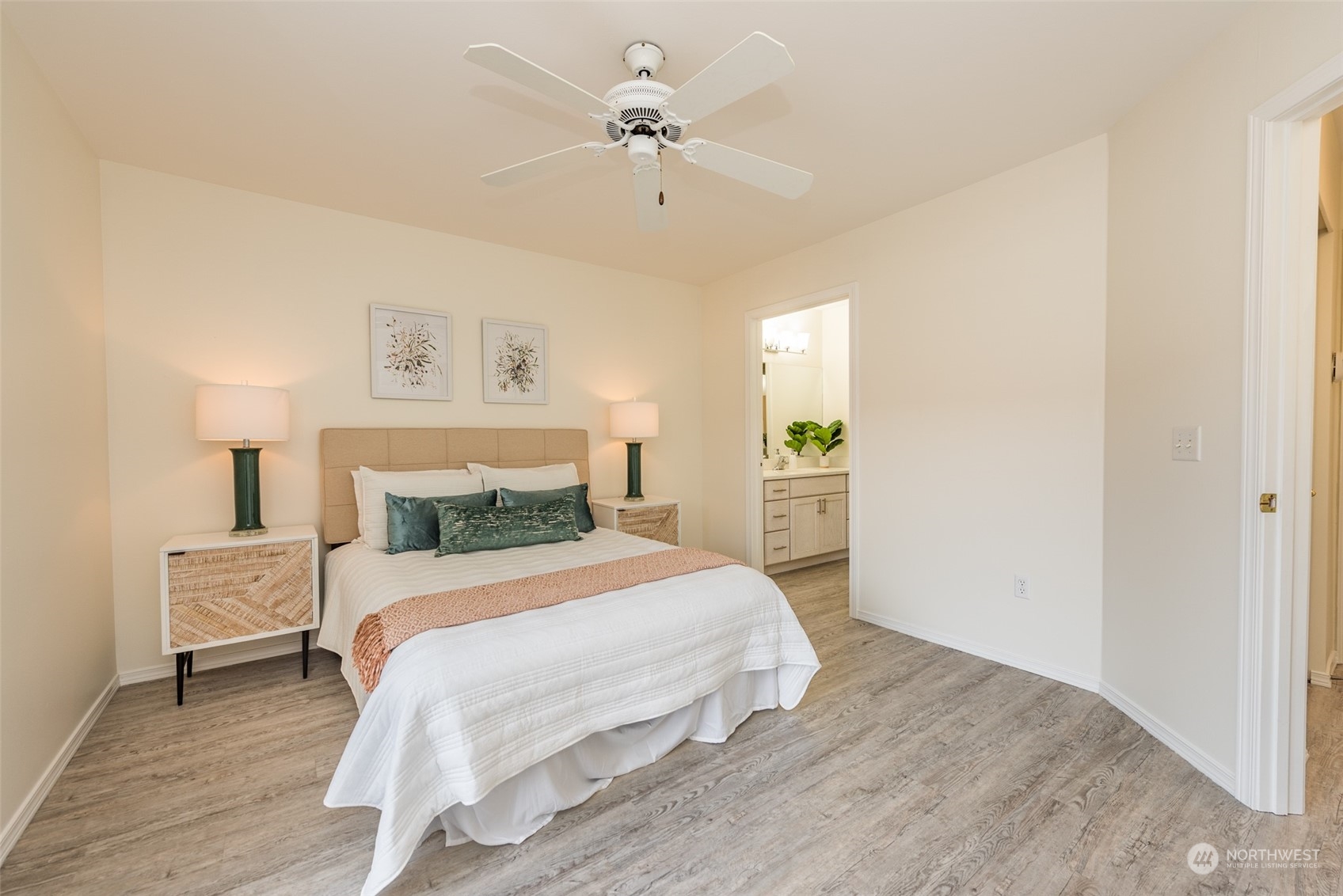 818 East Washington Place Sequim, WA 98382 - Photo 14 of 28 a bedroom with a bed and a chandelier