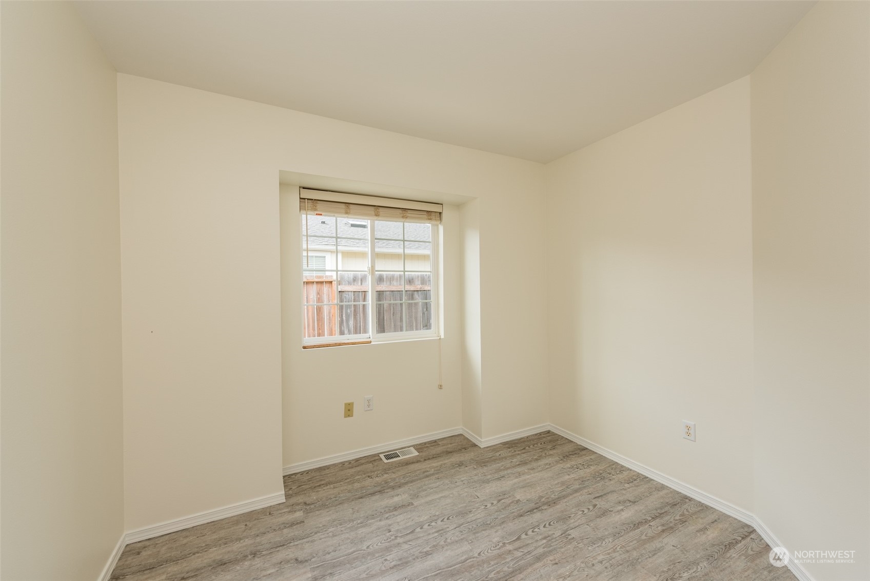 818 East Washington Place Sequim, WA 98382 - Photo 18 of 28 an empty room with wooden floor and windows