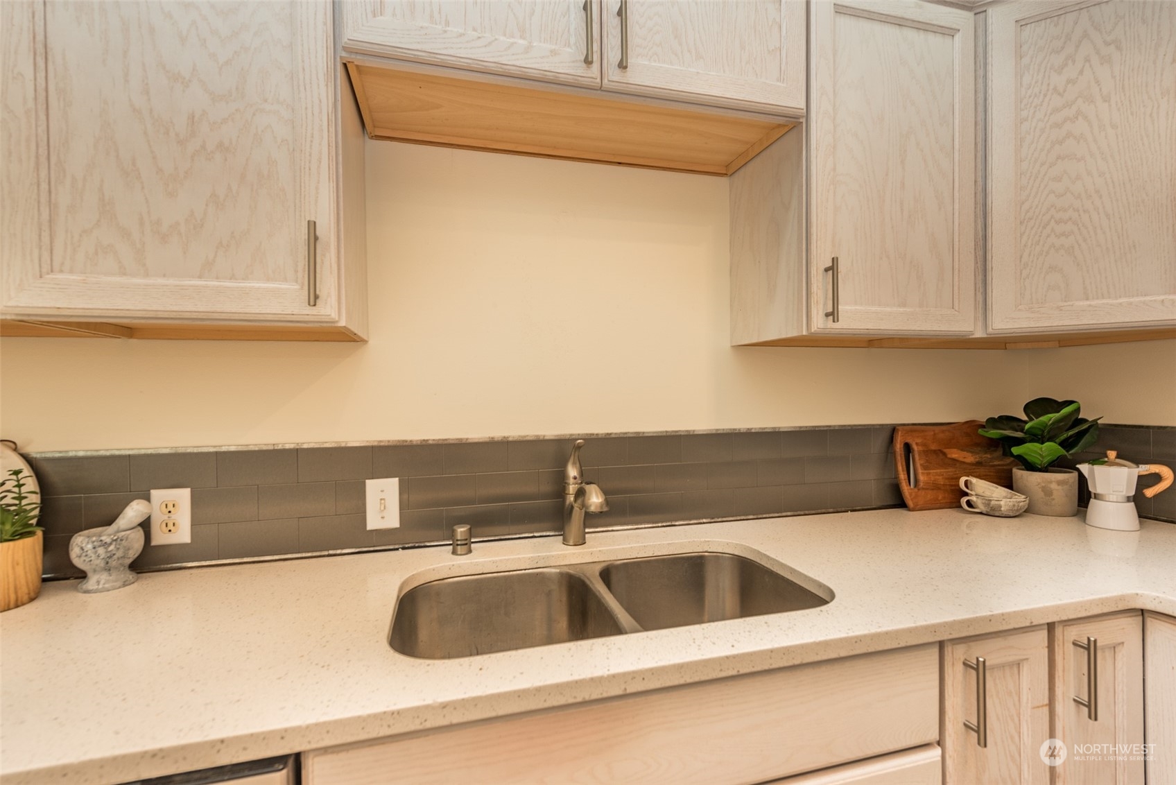 818 East Washington Place Sequim, WA 98382 - Photo 21 of 28 a kitchen with a sink and cabinets