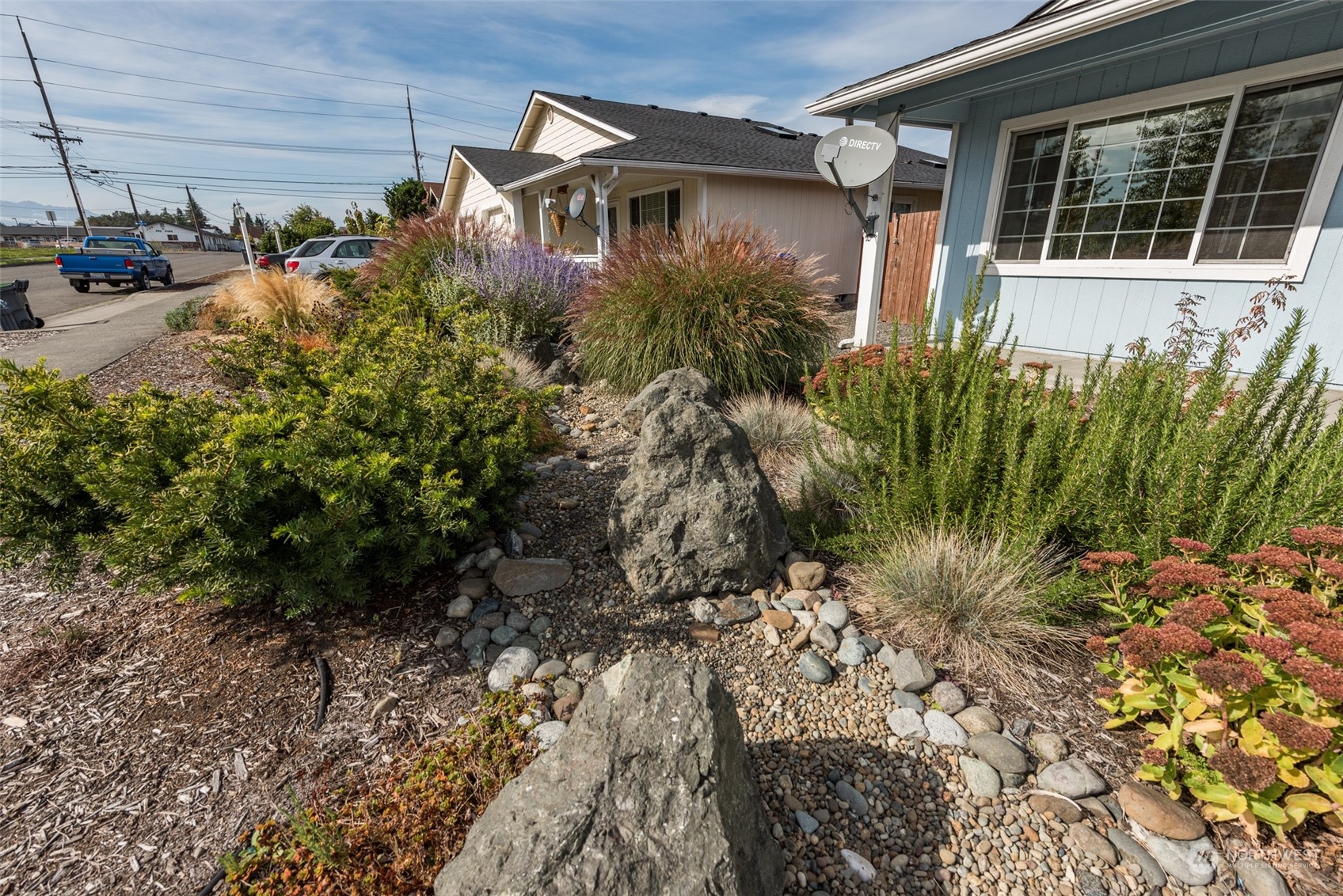 818 East Washington Place Sequim, WA 98382 - Photo 28 of 28 a vase of flowers sitting in front of a house