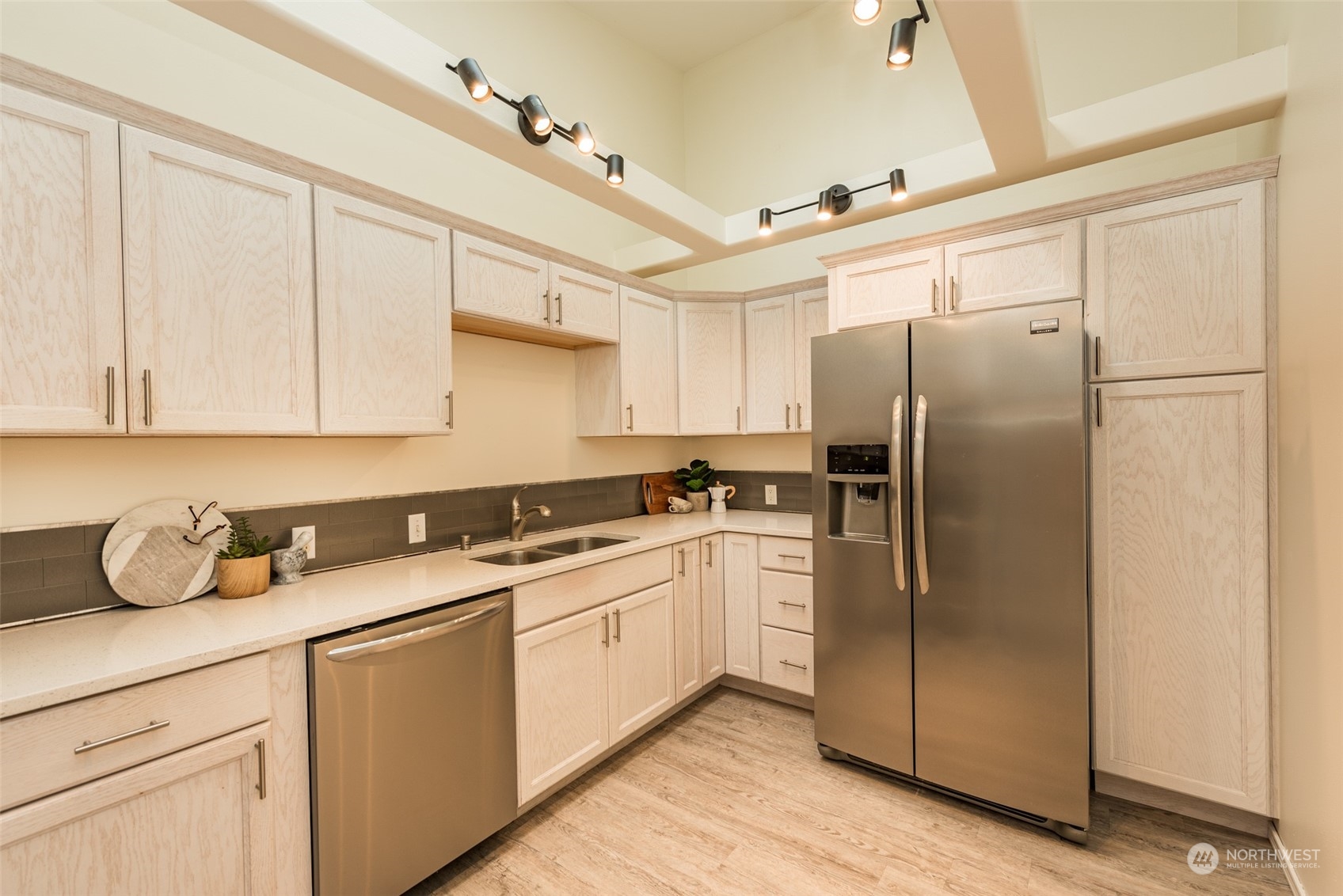 818 East Washington Place Sequim, WA 98382 - Photo 10 of 28 a kitchen with stainless steel appliances granite countertop a refrigerator sink and cabinets