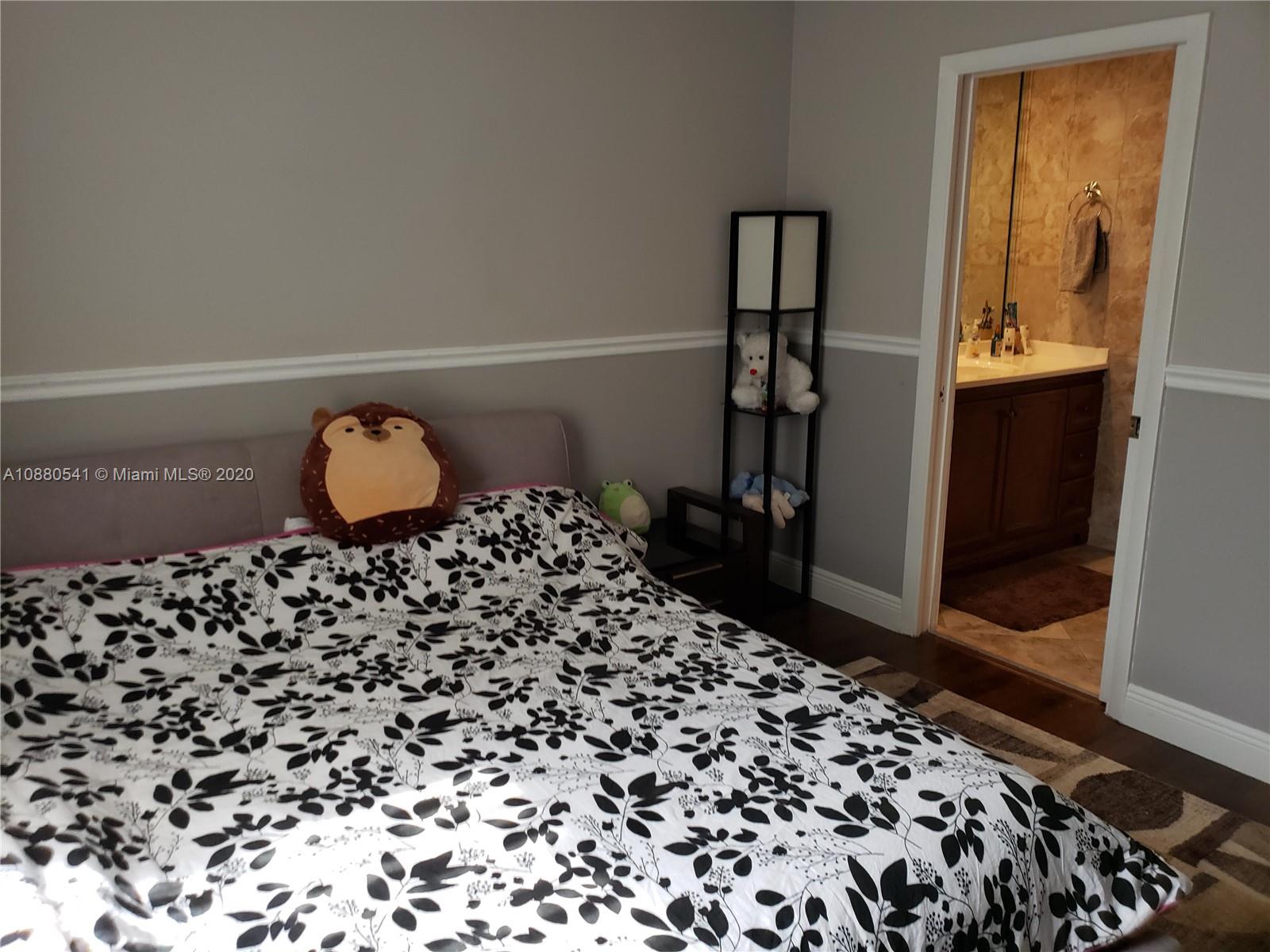 6466 Brava Way Boca Raton, FL 33433 - Photo 32 of 50 a large bed sitting in a bedroom next to a bathroom