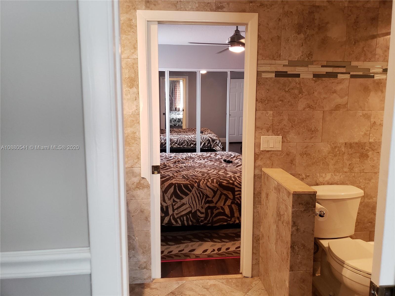 6466 Brava Way Boca Raton, FL 33433 - Photo 34 of 50 a bathroom with a granite countertop sink a toilet and shower