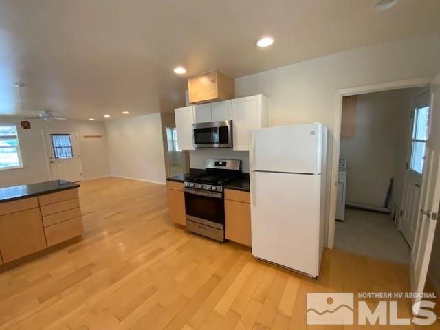 3830 Alcorn Road, Unit RD Fallon, NV 89406 - Photo 17 of 20 a kitchen with granite countertop a refrigerator and a stove top oven