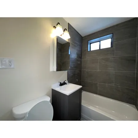a bathroom with a sink tub shower and a mirror