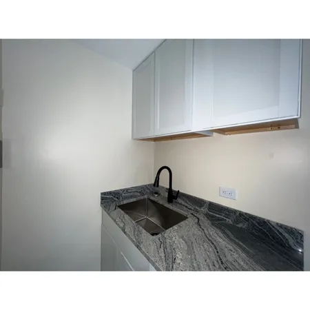a kitchen with a sink and cabinets