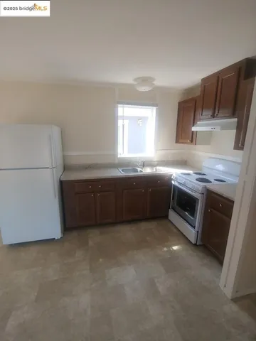 a kitchen with stainless steel appliances a sink and a refrigerator