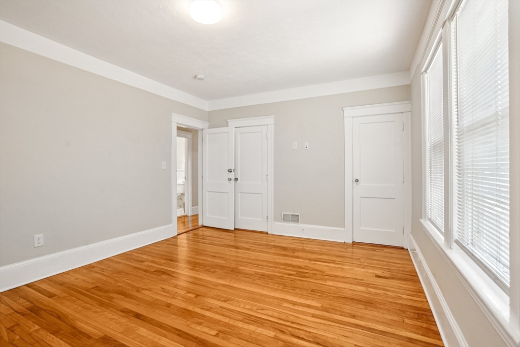 174 Park Avenue, Unit 1 Worcester, MA 01602 - Photo 17 of 34 a view of an empty room with wooden floor