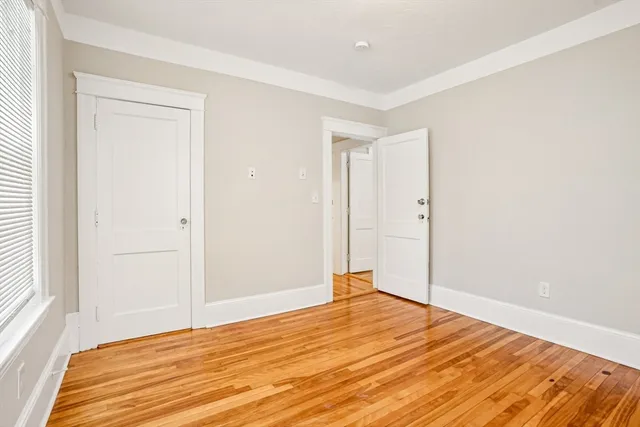 a room that has a bed and a window in it