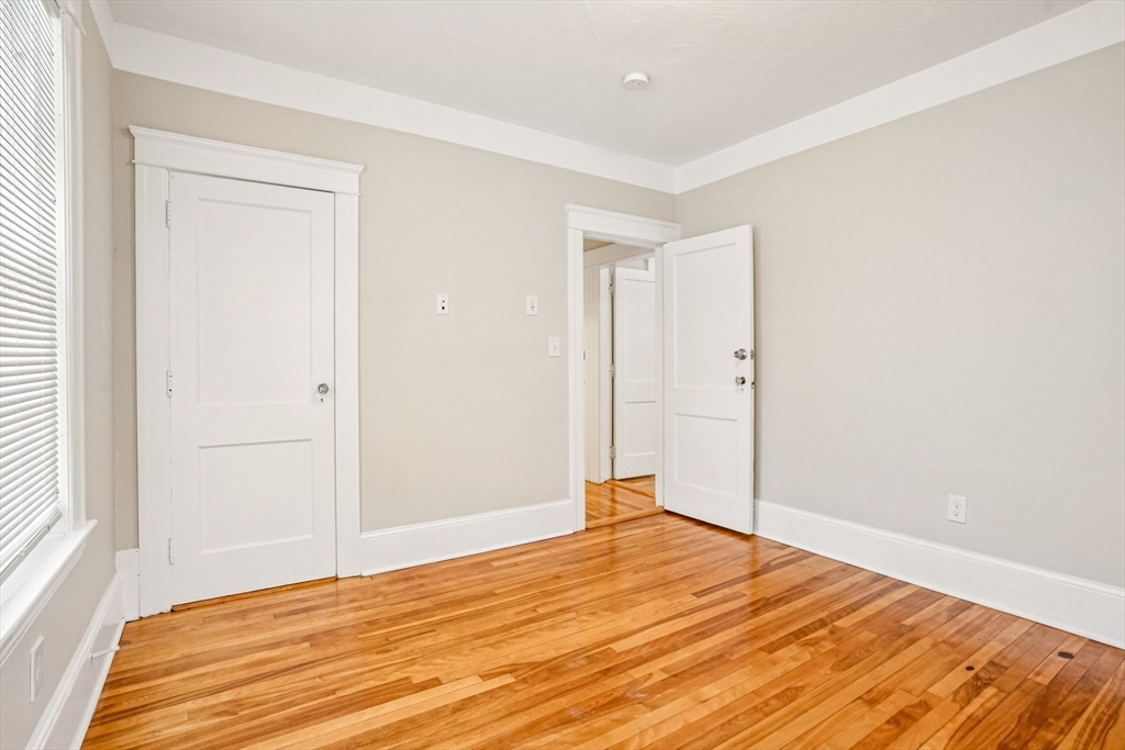 174 Park Avenue, Unit 1 Worcester, MA 01602 - Photo 19 of 34 a room that has a bed and a window in it
