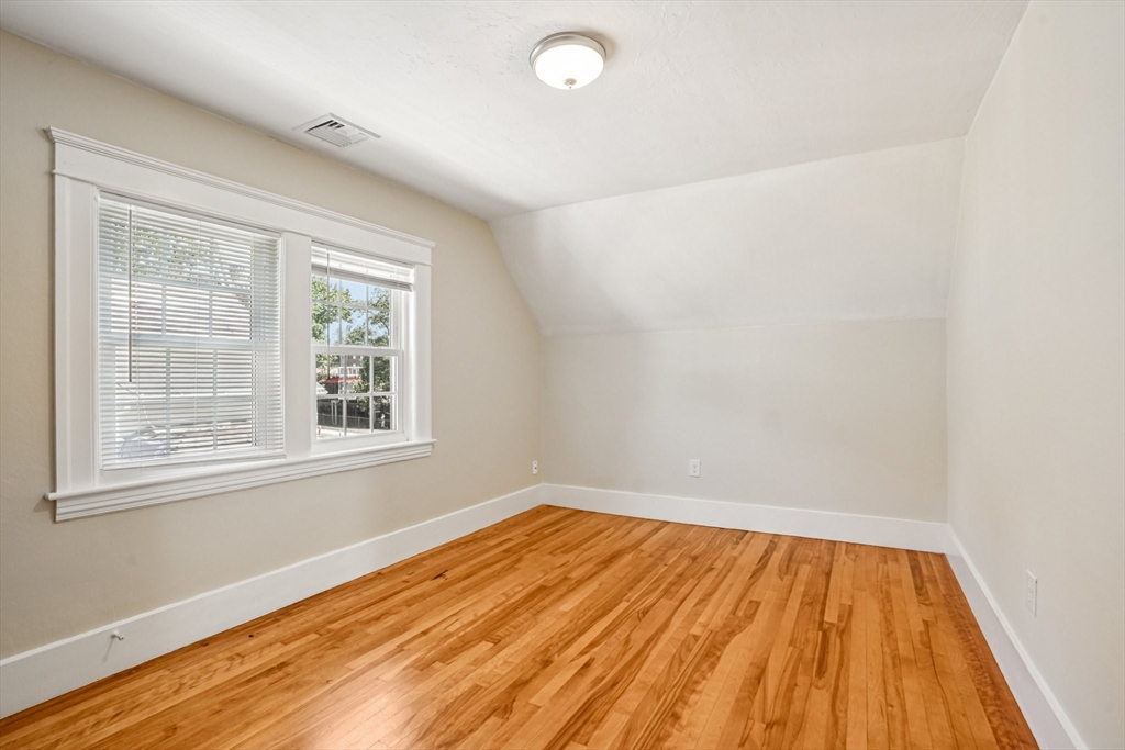 174 Park Avenue, Unit 1 Worcester, MA 01602 - Photo 22 of 34 an empty room with wooden floor and windows