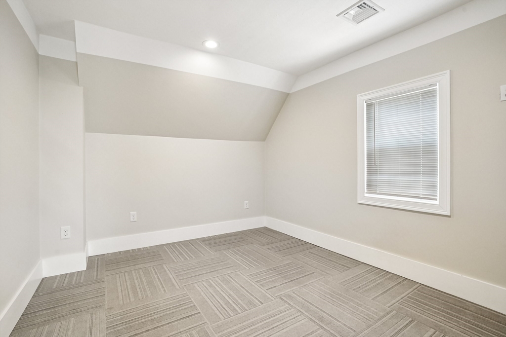 174 Park Avenue, Unit 1 Worcester, MA 01602 - Photo 26 of 34 an empty room with wooden floor and windows
