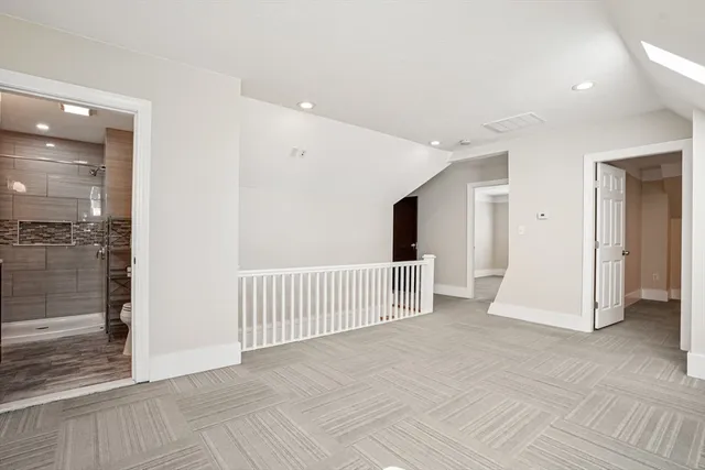 a bathroom with a shower sink and mirror