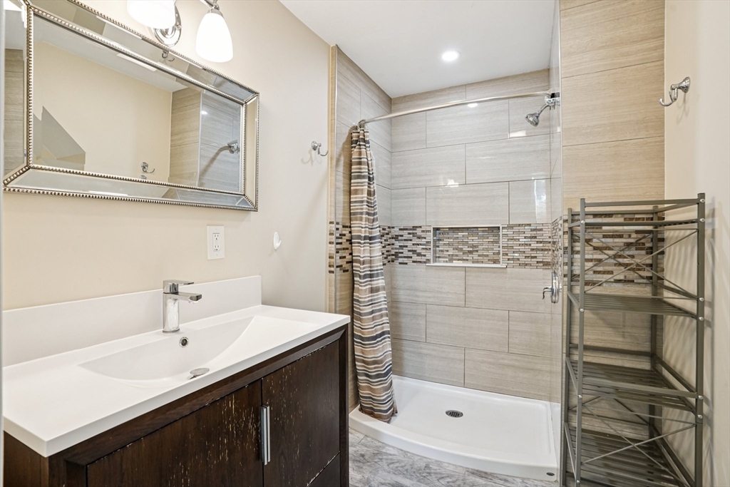 174 Park Avenue, Unit 1 Worcester, MA 01602 - Photo 29 of 34 a bathroom with a shower sink and mirror