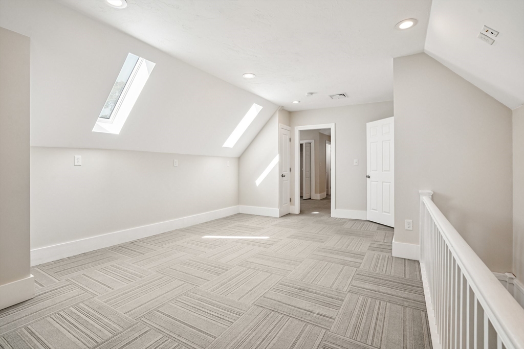 174 Park Avenue, Unit 1 Worcester, MA 01602 - Photo 30 of 34 a view of an empty room with wooden floor
