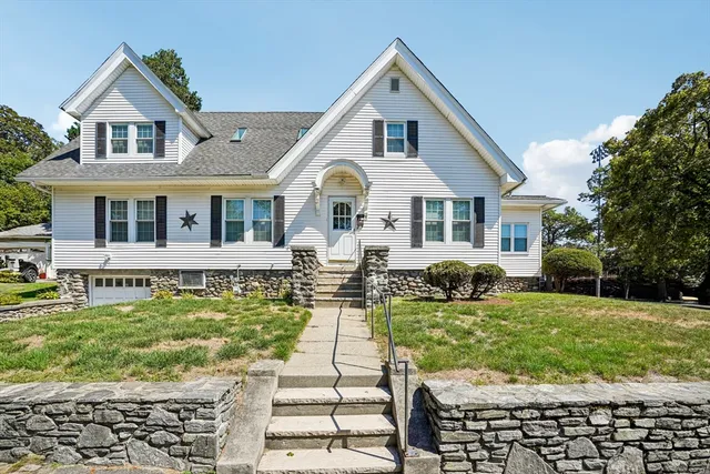a front view of a house with a yard