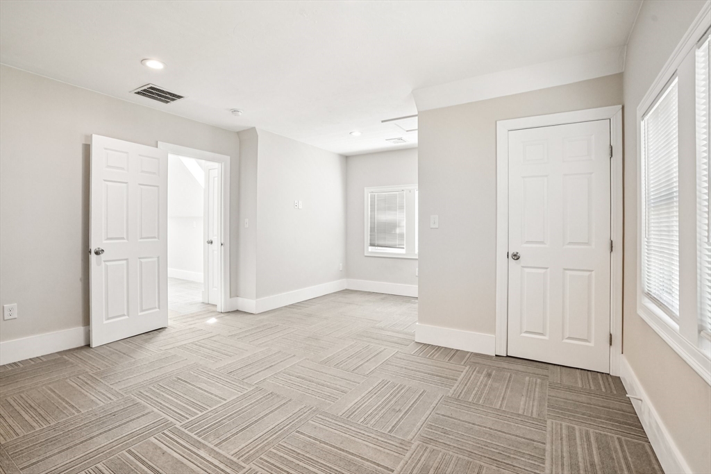 174 Park Avenue, Unit 1 Worcester, MA 01602 - Photo 32 of 34 a view of an empty room with window and closet area