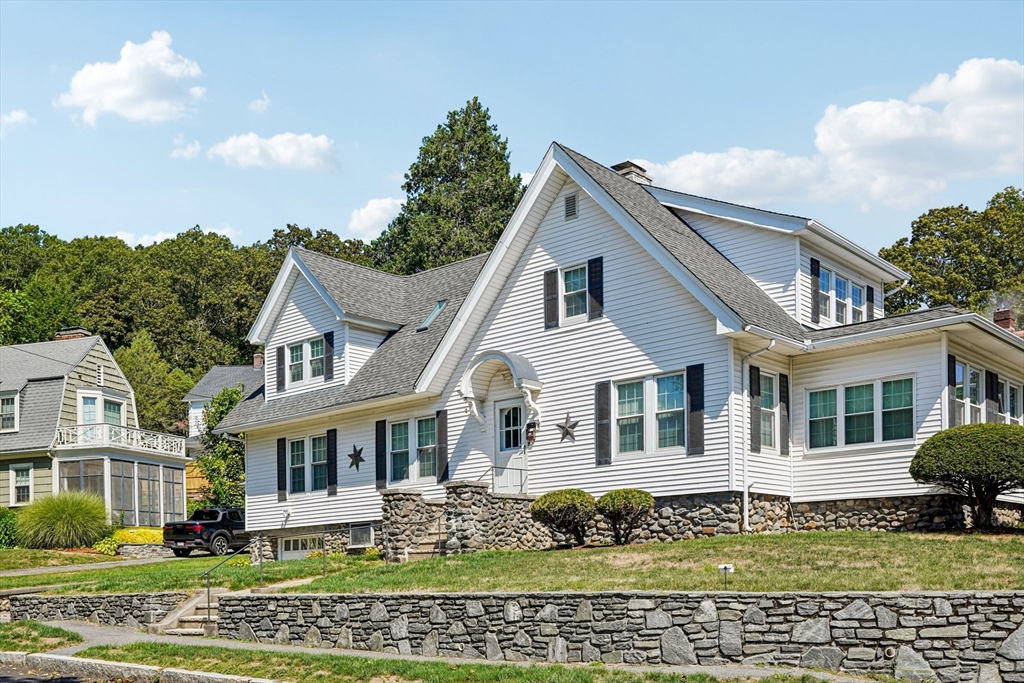 174 Park Avenue, Unit 1 Worcester, MA 01602 - Photo 4 of 34 a front view of a house with a garden and plants
