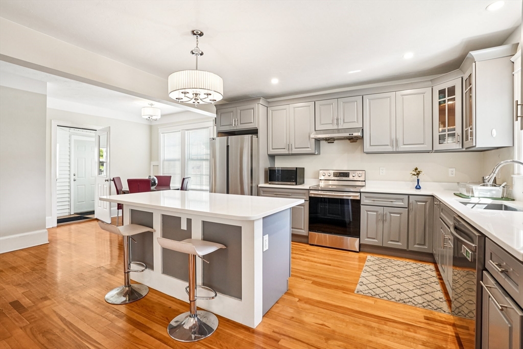 174 Park Avenue, Unit 1 Worcester, MA 01602 - Photo 6 of 34 a kitchen with a stove a refrigerator and a stove top oven