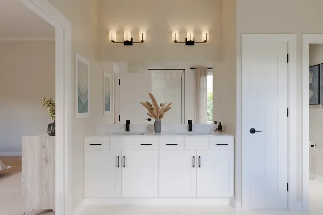 a bathroom with double vanity and a mirror