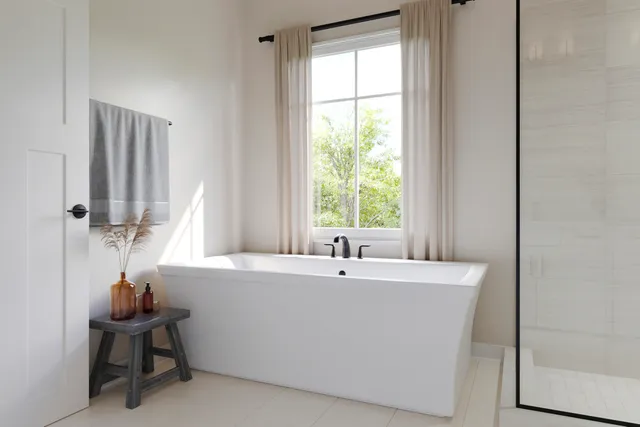a white bath tub sitting next to a window