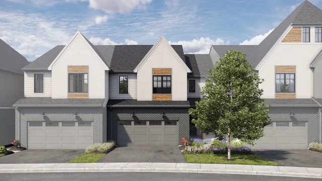 a front view of house with garage and trees
