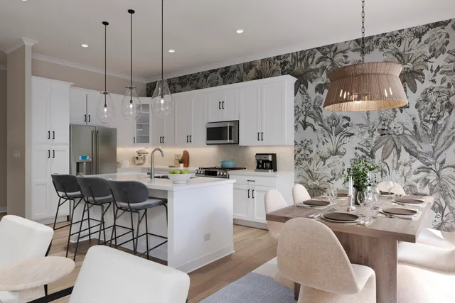 a kitchen with stainless steel appliances kitchen island granite countertop a sink and a refrigerator