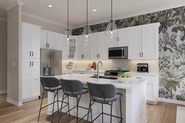 a kitchen with stainless steel appliances a stove a sink refrigerator and a microwave