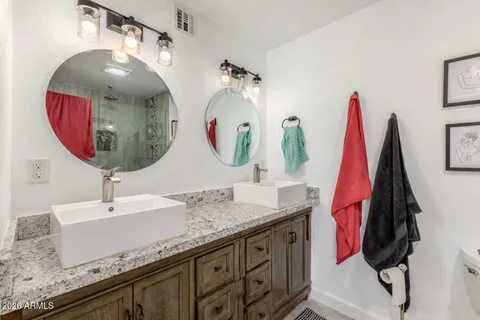 a bathroom with a sink vanity and a mirror