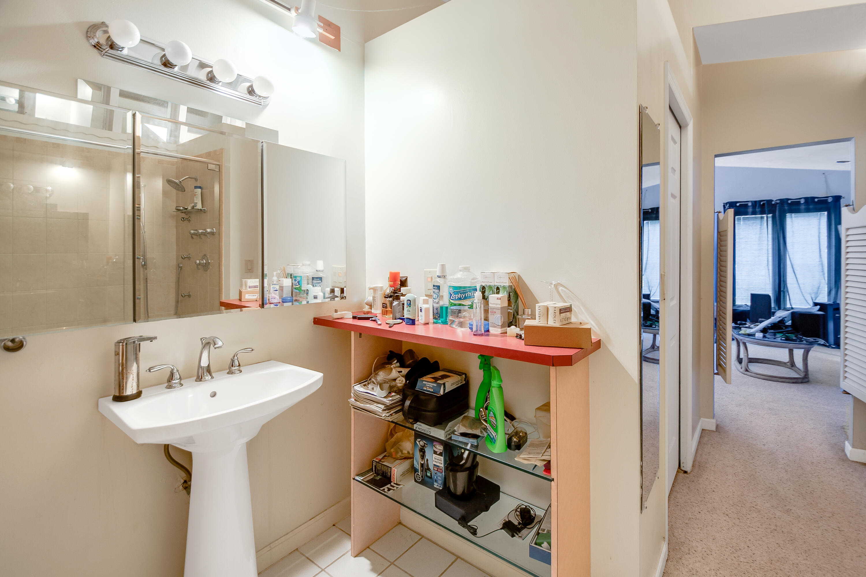 11 Capri Boulevard Naples, FL 34113 - Photo 14 of 39 a bathroom with a sink and mirror