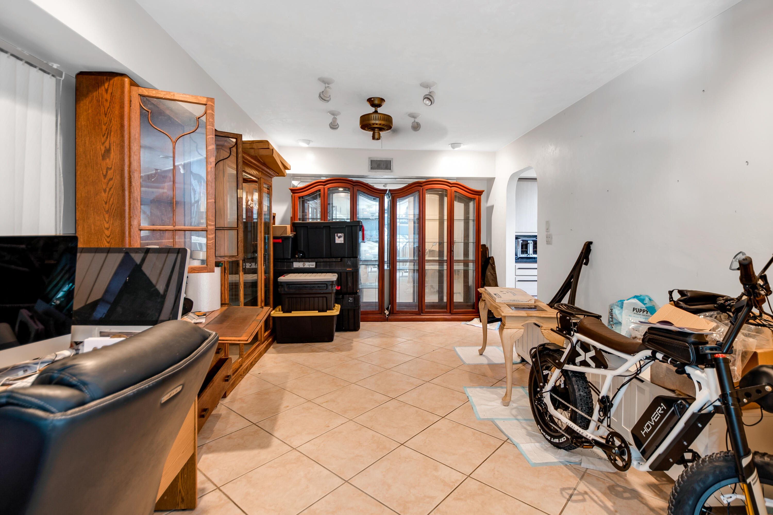 11 Capri Boulevard Naples, FL 34113 - Photo 7 of 39 a living room with furniture a flat screen tv and floor to ceiling window