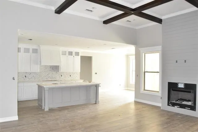 a large white kitchen with a large window