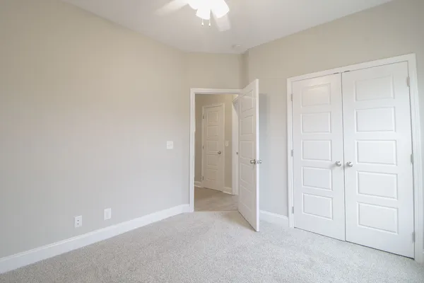 a view of an empty room and closet area