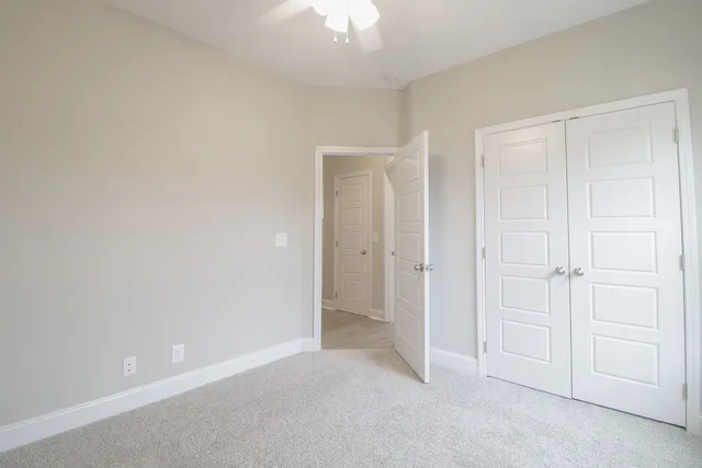 a view of an empty room and closet area