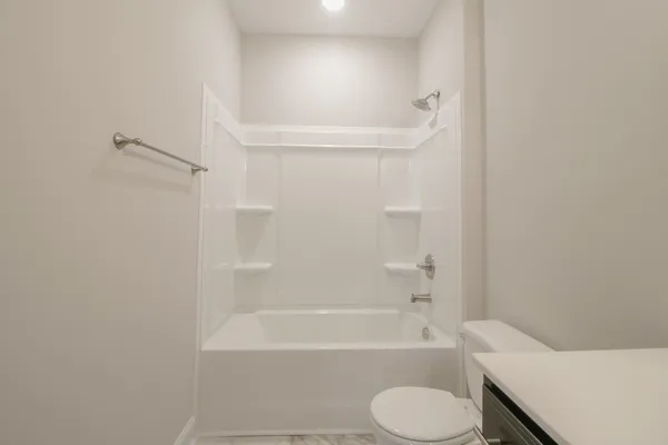 a bathroom with a toilet and bathtub