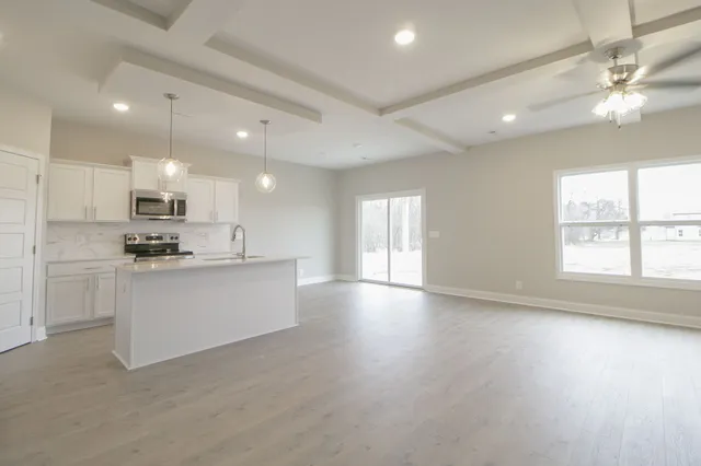 a view of kitchen with center island and stainless steel appliances