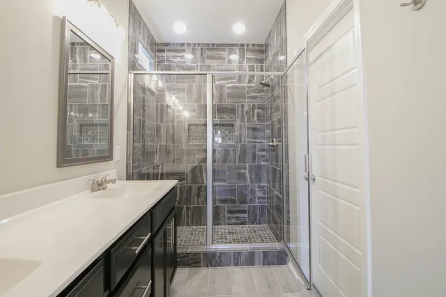 a bathroom with a shower and a sink