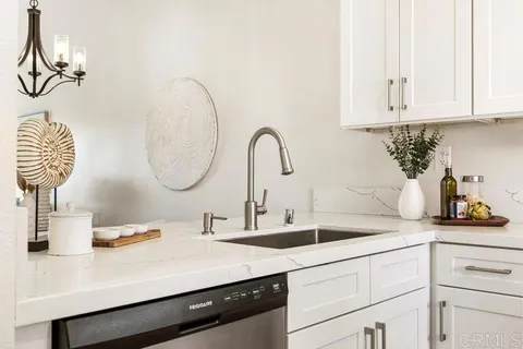 a kitchen with a sink and a white cabinets